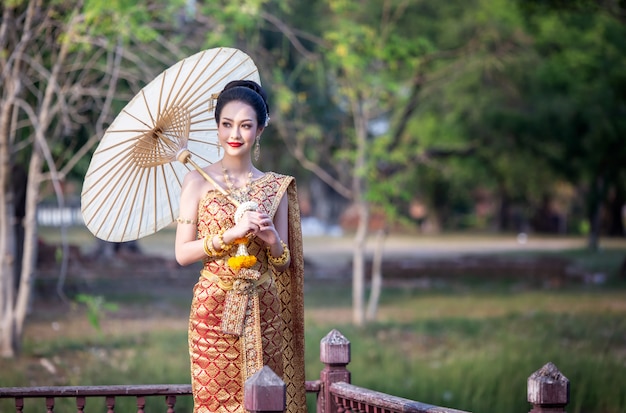 Women in Thailand Traditional Costume holding umbrella 