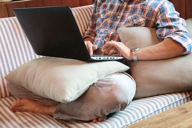 Women touching screen and man typing laptop on wood table