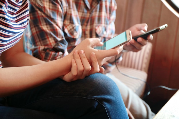 Women touching screen and man typing laptop on wood table