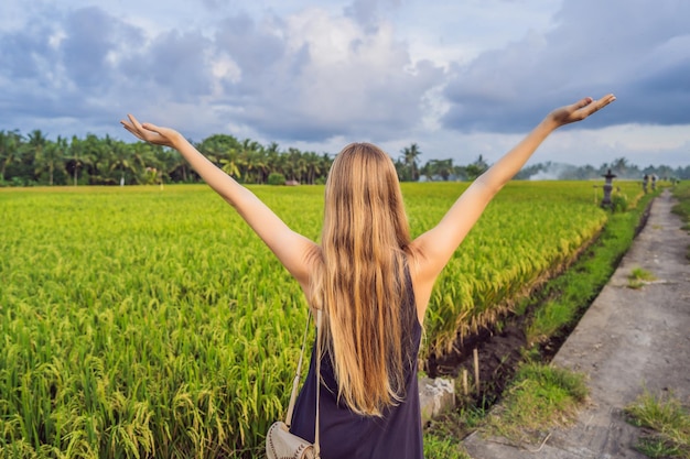 Women tourists enjoy the panoramic view of the beautiful Asian scenery of rice fields