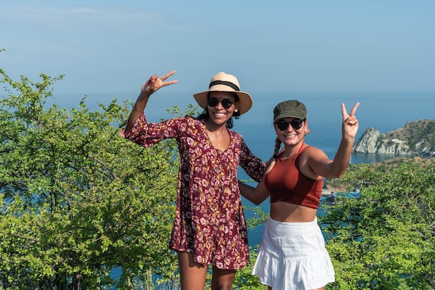 Women tourists at the top of the mountain during a summer hike.