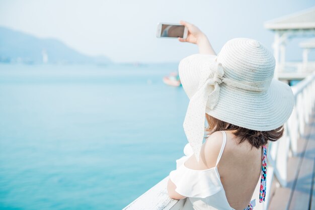 Women travel alone at the sea and beach on Summer. Chonburi Thailand.