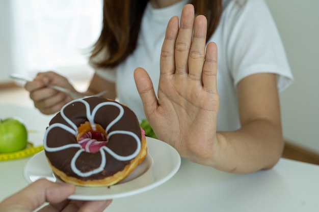 The women used to push the donut plate with the people. Do not eat desserts for weight loss.