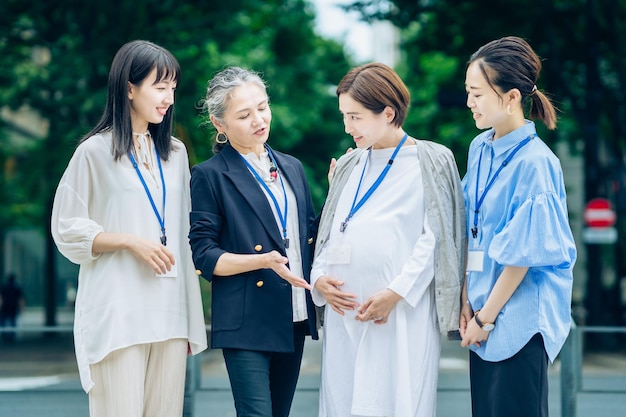 Women of various ages talking to pregnant woman