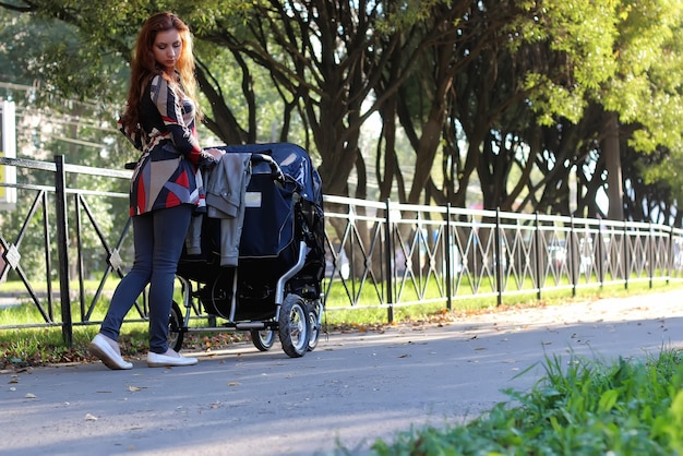 Photo women walk stroller summer