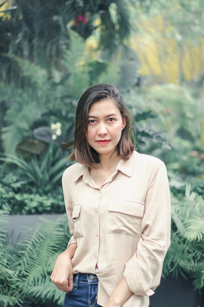 Women wearing brown shirts posing in the garden