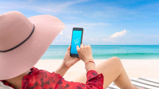 Women wearing widebrimmed hats Sit back and relax on the beach on a sunny day