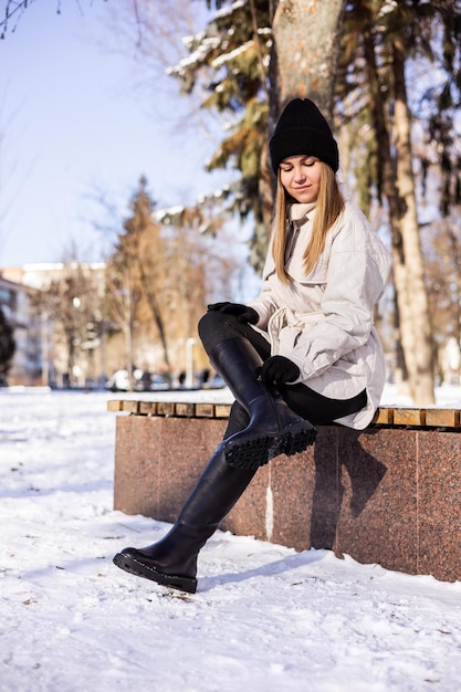 Women in white winter coats and black leather boots Street style casual women's fashion Winter women's style