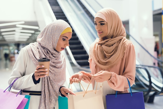 Women with Cup of Coffee Standing in Mall