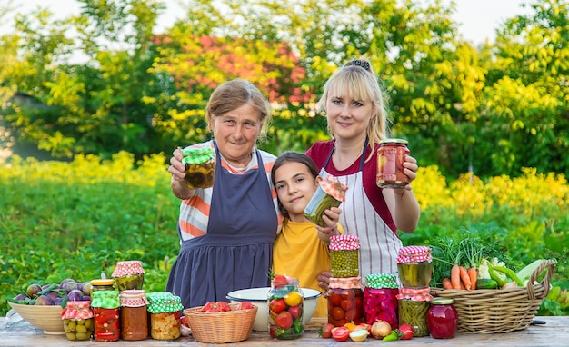 Women with jar preserved vegetables for the winter mother and daughter Selective focus