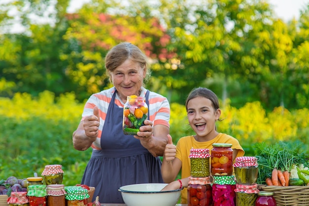 Women with jar preserved vegetables for the winter mother and daughter Selective focus