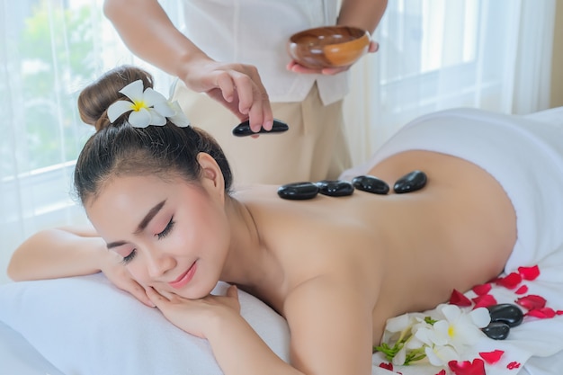 Women with therapeutic stones on her back