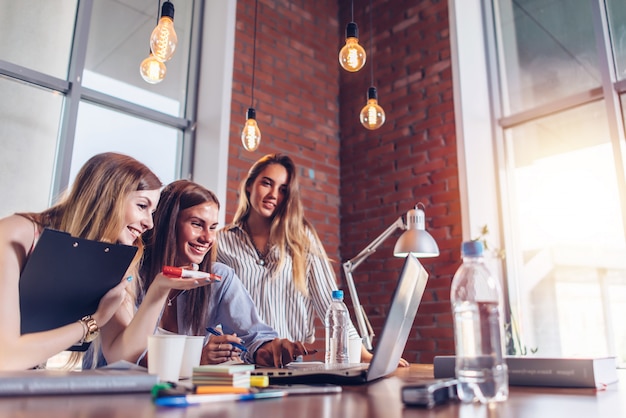 Women working on laptop discussing joint business project