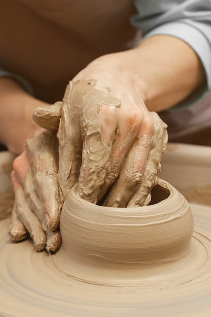 Women working on the potters wheel close up