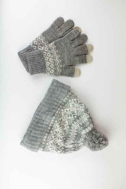 Women39s winter knitted mittens with a hat on a white background