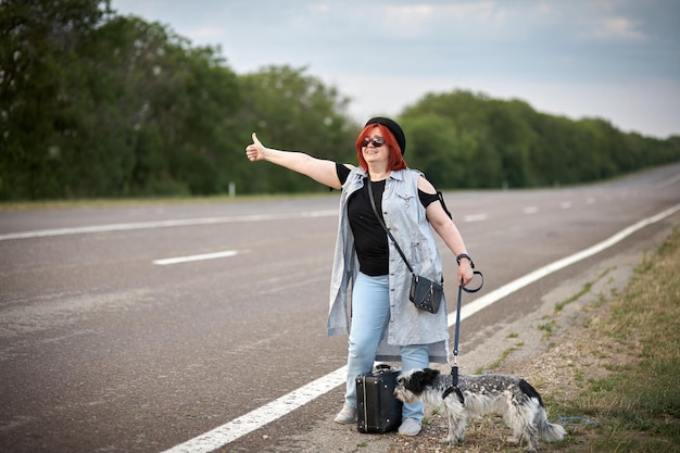 Womenon the road with dog stoped auto