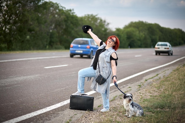 Womenon the road with dog