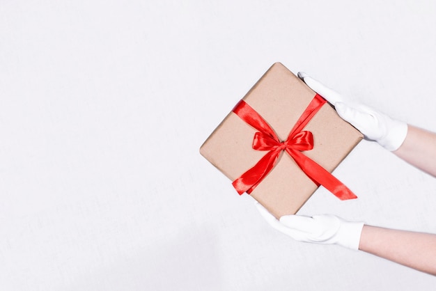 womens hands holding a box with a gift