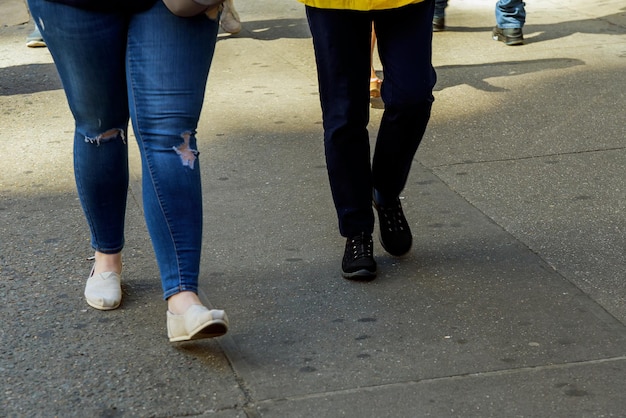 Womens legs walking on a pedestrian crossing on a sunny day