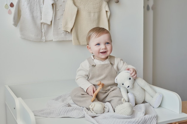 Wonderful baby boy with blue eyes Child playing with toys in nursery Early development kindergarten nursery playroom Children's Day Mother's Day