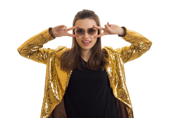 Wonderful bright girl in glasses and a gold jacket posing in Studio isolated on white background