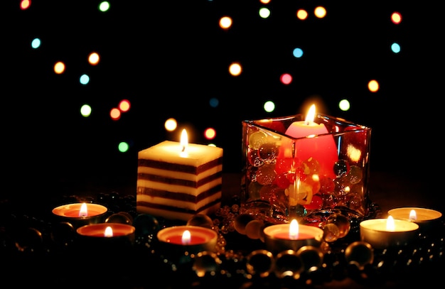 Wonderful composition of candles on wooden table on bright background