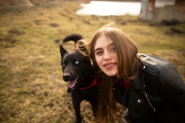 A wonderful portrait of a girl and her dog with colorful eyes. 