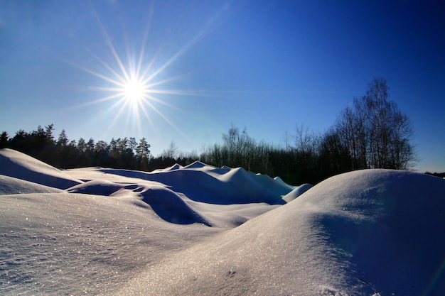 Wonderful winter landscape Beautiful morning landscape of small snowy hills in winter Frosty sunny morning The beauty of winter and the warmth of the sun