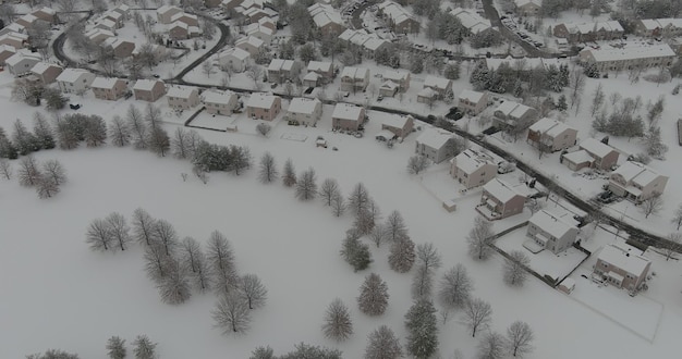 Wonderful winter scenery roof houses snowy trees covered on the aerial view with residential small t