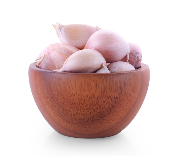 wood bowl with garlic on white background