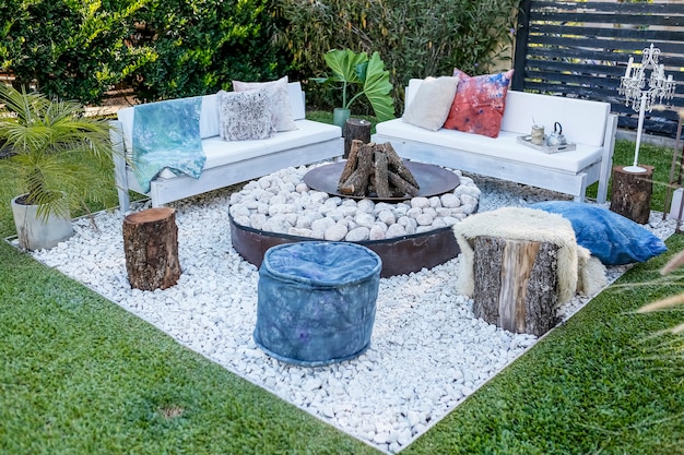 Wood fire and stones with benches in the garden