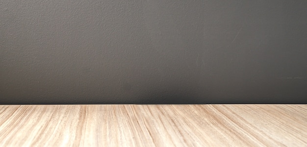 wood floor and black cement wall