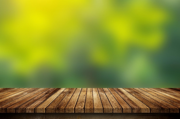 Wood floor with blurred trees of nature park background and summer season product display montage