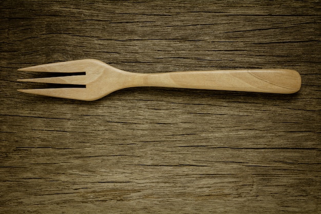 Photo wood fork on old wooden desk. - vintage style.