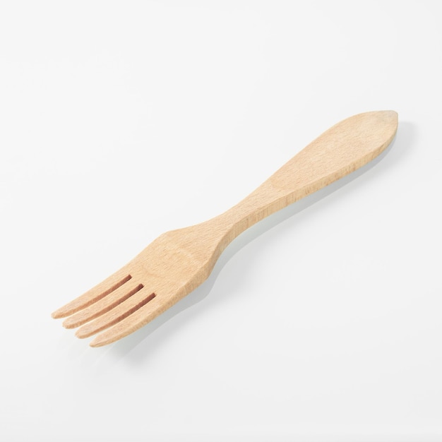 Wood kitchen utensils wooden fork on a white mirror background