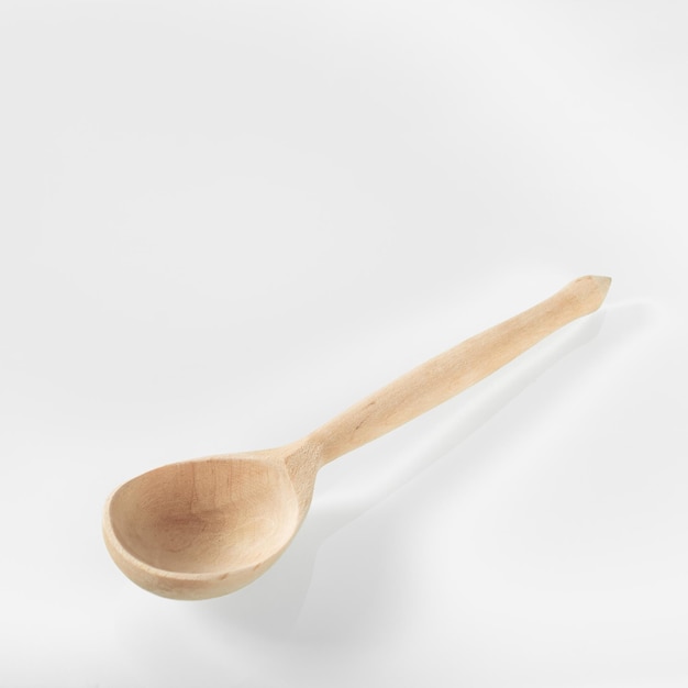 Wood kitchen utensils wooden spoon on a white mirror background