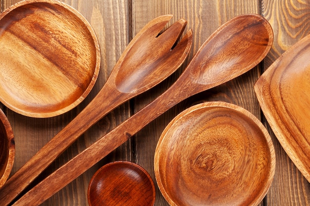 Wood kitchen utensils over wooden table background