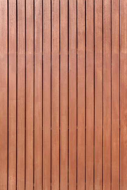 Photo wood paneling background texture. ipe teak wood pattern tropical wood. building facade backdrop