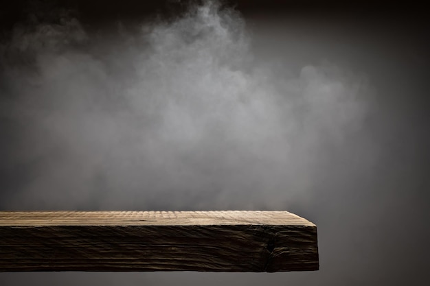 Wood plank podium with smoke in the dark