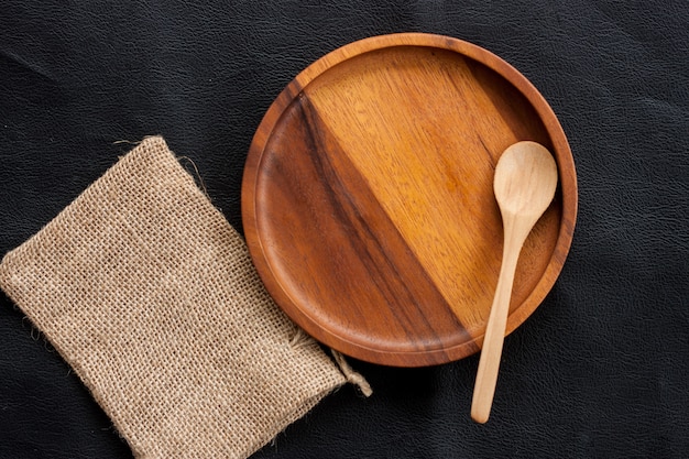 wood plate and wood spoon put on sack in kitchen homemade