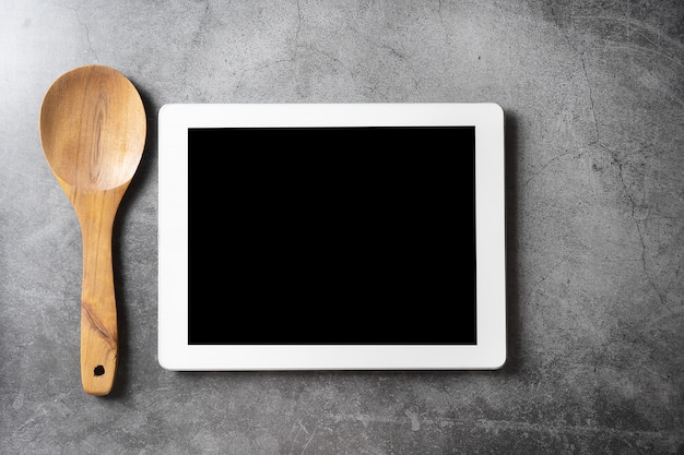 Wood spoon tablet on dark floor