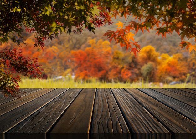 Wood table in autumn landscape with empty copy space for product display mockup.