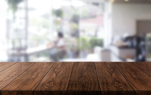 Wood table in blurry background of modern restaurant room or coffee shop for product display