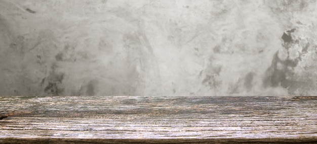 Wood table display over blur Texture of old gray concrete