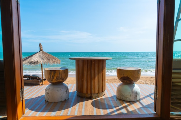 Wood table stool and chair with sea beach background