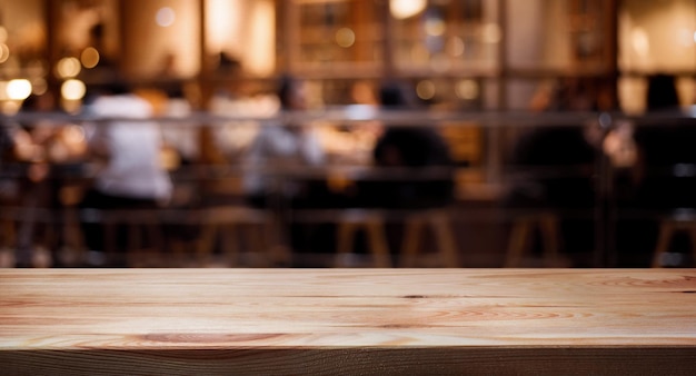 Wood table top on blurred of cafe restaurant with light gold in dark nigh background