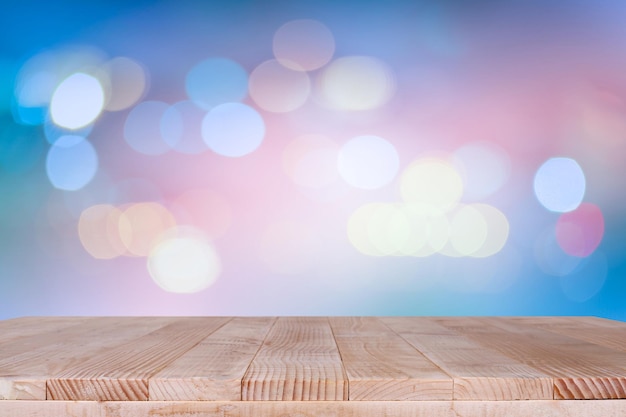 Wood table top on bokeh orange background can be used for montage or display your products