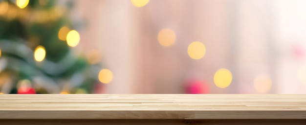 Wood table top on colorful bokeh background from decorative light on Christmas tree