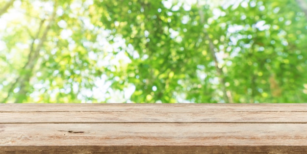 Wood table top in front of natural blur bokeh background and copy space. display or montage products