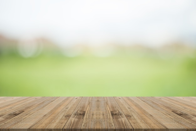 Wood table top on nature green blurred background,for montage your products